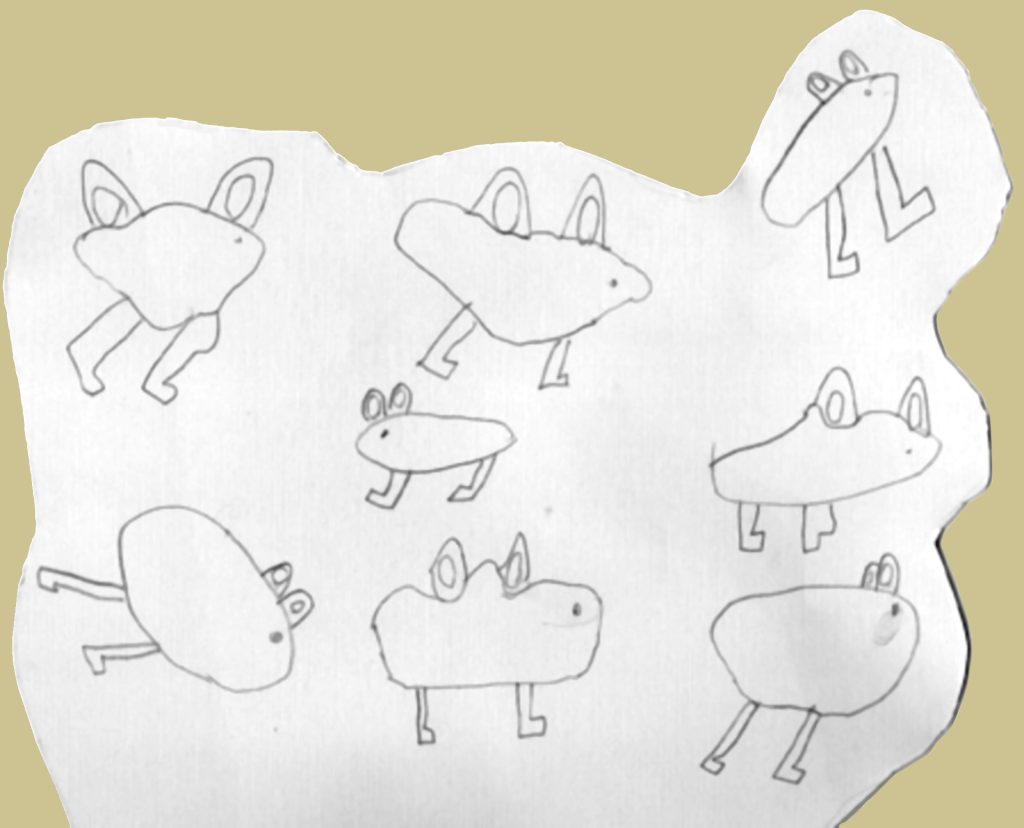 Rabbits drawn by a seven year old on a piece of cardboard.