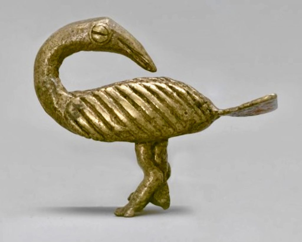 A sculpture of a bird looking over its shoulder, made of gold.