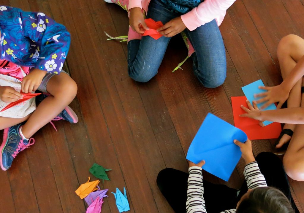 Children folding paper.